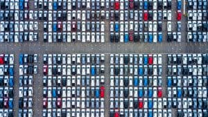 An aerial view of a parking lot full of cars.