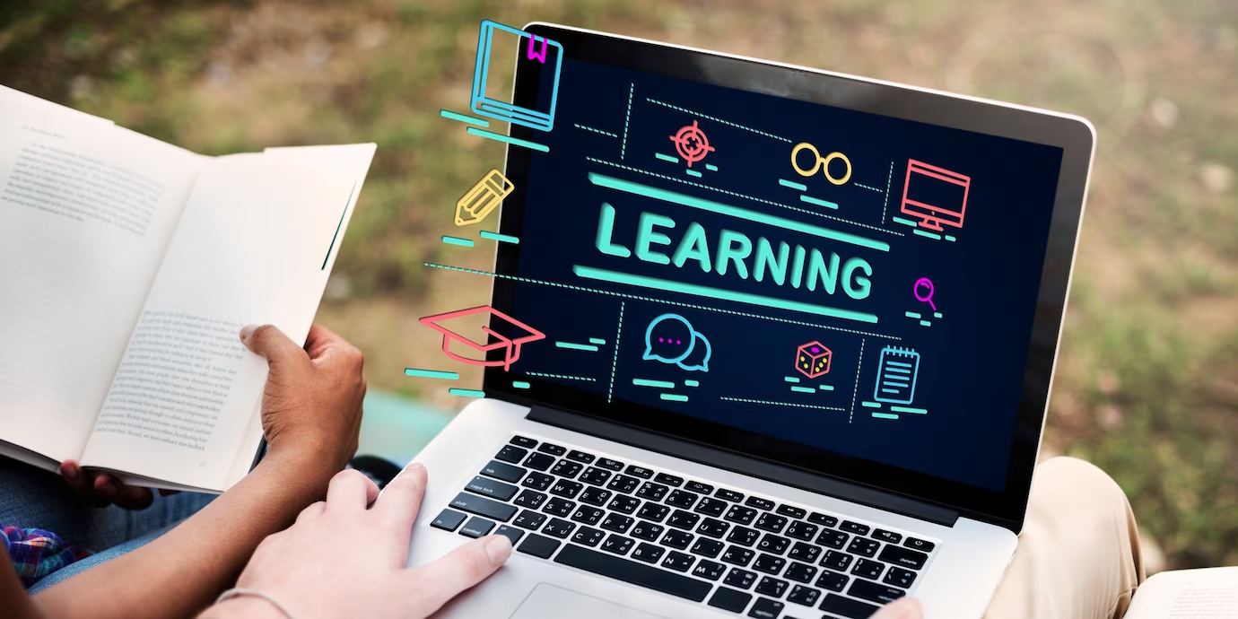 two people using a laptop with the word learning on it.